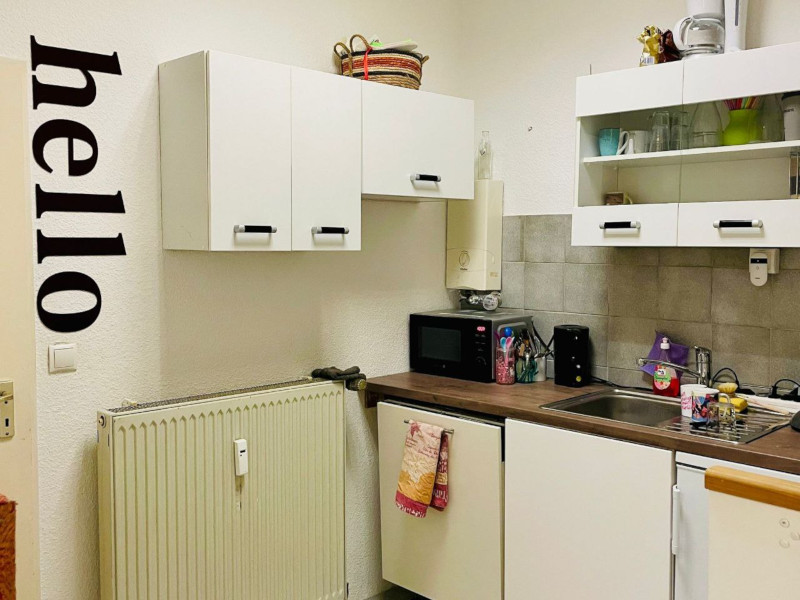 a white kitchen with a wand tattoo saying the word hello