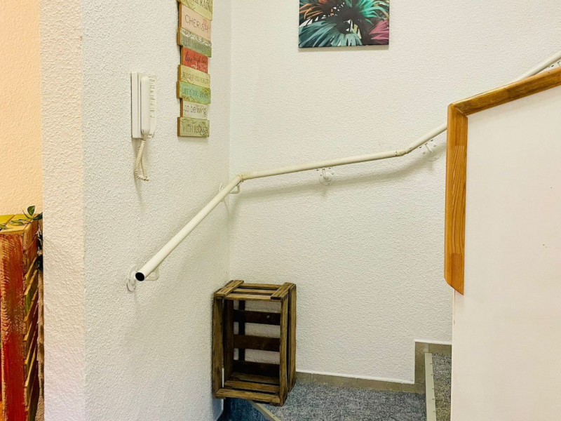 stairs with blue carpet leading upstairs
