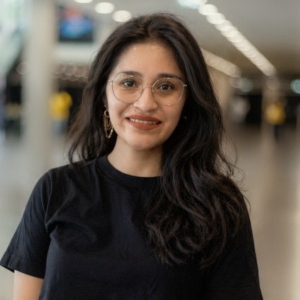 Young woman in black shirt smiling at camera